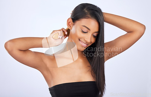 Image of Woman brush hair, beauty and haircare cosmetics, keratin treatment and smile on studio background. Happy, Indian female grooming with straight hairstyle and skin glow, Brazilian and cosmetic care