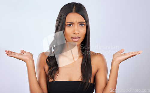 Image of Indian woman, hair care or confused in studio portrait for healthy natural shine options or beauty choices. Face of young girl model, doubt or curly styling cosmetics in grooming on white background