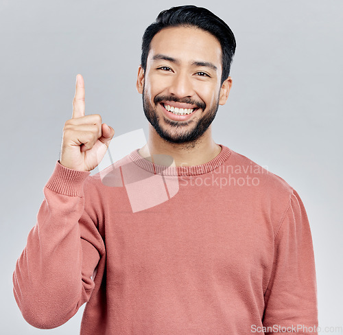 Image of Smile, space and portrait of Indian man pointing up, mockup and product placement isolated on white background. Promotion, information and person showing deal announcement in studio with launch idea.