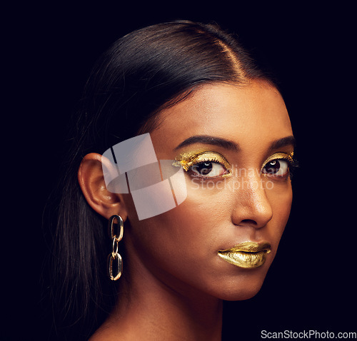 Image of Indian woman, festive makeup and studio portrait for beauty, wellness and celebration by black background. Model, asian girl or dark aesthetic with gold lipstick, jewellery and cosmetics for face art