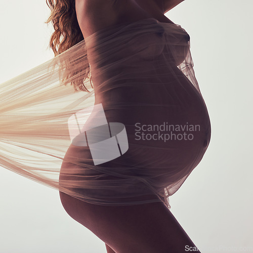 Image of Woman, pregnancy and fabric with silhouette in studio with hands, touch and art by white background. Pregnant model, shadow and mom wellness with cloth for body, belly or stomach with dark aesthetic