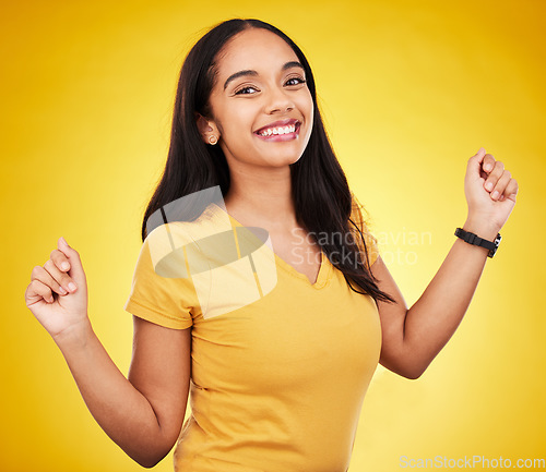 Image of Happy, young and portrait of a beautiful woman isolated on a yellow background in a studio. Casual, smile and a gorgeous girl looking cheerful, cute and fashionable in a bright shirt on a backdrop