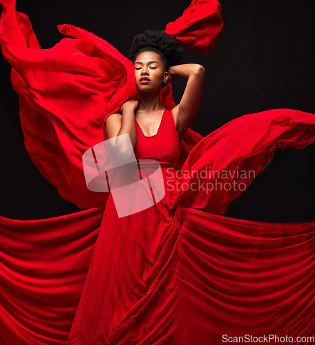 Image of Black woman, art and fashion, red fabric on dark background with motion and aesthetic movement. Flowing silk, fantasy and artistic beauty, stylish African model in creative designer dress in studio.