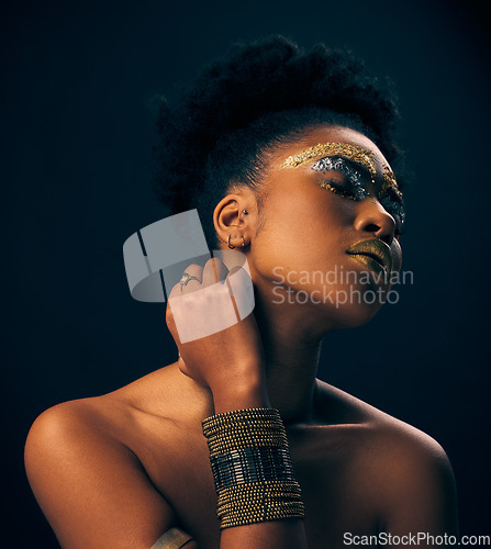 Image of Beauty, gold and jewelry with black woman and makeup in studio for luxury, cosmetics and African pride. Natural, creative and goddess with female model on background for queen, bronze and glamour