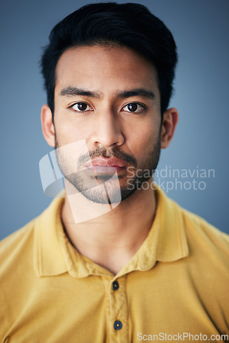 Image of Focus, serious and portrait of a male in studio with moody, sadness or mental health problem. Tired, concentrating and Indian man model with burnout face expression isolated by gray background.