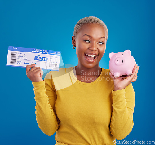 Image of Piggy bank, travel ticket and black woman with savings in blue studio with flight, boarding passport and investment. Traveling mockup, money and girl celebrate immigration, holiday or global vacation