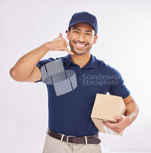 Image of Call me, delivery man and courier with phone gesture an happy to deliver package as ecommerce in studio white background. Shipping, excited and employee or person with parcel using cellphone sign