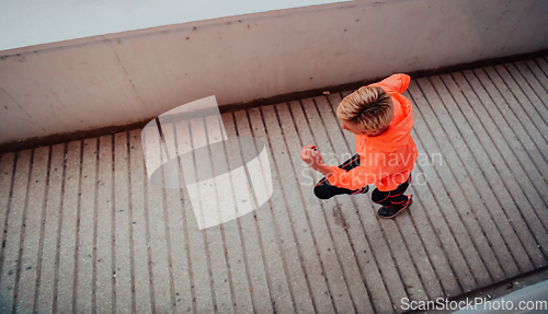 Image of Women in sports clothes running in a modern urban environment et night time. The concept of a sporty and healthy lifestyle