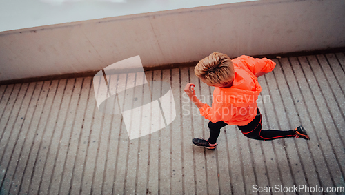 Image of Women in sports clothes running in a modern urban environment et night time. The concept of a sporty and healthy lifestyle