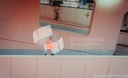 Image of Women in sports clothes running in a modern urban environment et night time. The concept of a sporty and healthy lifestyle