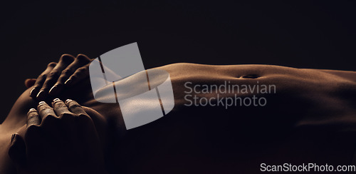 Image of Stomach, woman and breast silhouette dark background of skin, body and model with glow, light and art on black. Hands of aesthetic person in studio for abstract, creativity and shadow or space