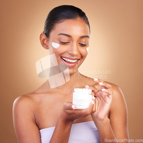 Image of Skincare, beauty product lotion and glow of a happy woman with cosmetic and cream. Isolated, studio background and model with a smile from face cleaning, cosmetics and dermatology facial sunscreen