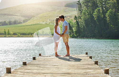 Image of Couple holding hands on jetty, relax by lake and summer, travel and adventure, love and care outdoor. People in relationship, trust and bonding on vacation, man and woman are content with freedom