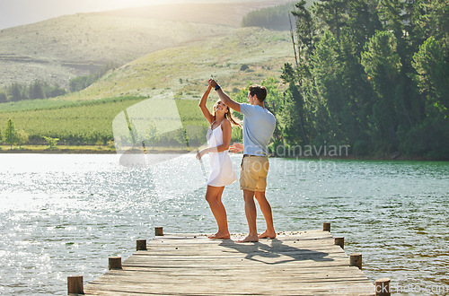 Image of Lake, dancing and happy nature couple on outdoor quality time together, fun countryside adventure or bonding getaway. Freedom peace, water and playful woman, man or romantic people dance on love date