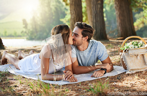 Image of Couple kiss, love and picnic in forest, summer with freedom and adventure, relationship with affection and care outdoor. People together in nature park, commitment and trust with romance and bonding