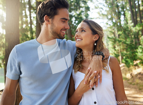 Image of Couple in nature, holding hands and happy relationship with love and trust, travel and adventure in park. Young people hug in forest, outdoor and happiness together with smile, commitment and care