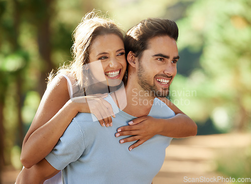 Image of Couple in park, smile and piggy back, happy relationship with love and trust, travel and adventure in nature. Young people in forest, outdoor and happiness together with freedom, commitment and care