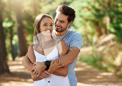 Image of Couple hug in nature park, happy and relationship with love and trust, travel and adventure. Young people in forest, outdoor and happiness together with smile, embrace with commitment and care