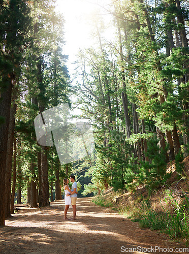 Image of Love, nature and forest couple hug on outdoor quality time together, hiking adventure or woods bonding journey. Peace, freedom and trekking woman, man or romantic people embrace on wilderness date