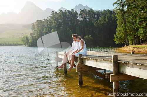 Image of Love, happy and deck with couple at lake for bonding, romance and affectionate date. Nature, travel and holiday with man and woman cuddling on boardwalk in countryside for view, summer and vacation