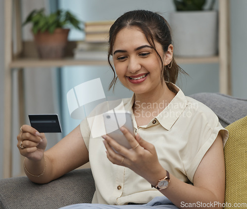 Image of Happy woman, credit card and online shopping on smartphone in home for digital payment, fintech or money transfer. Female, mobile banking and finance of cash, web sales and password for financial app