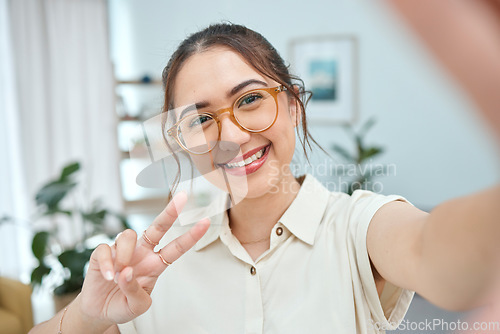 Image of Woman, smile in selfie with peace hand sign, emoji and social media influencer with post or live streaming. Young female person, gen z and happy posing in picture, memory and content creation