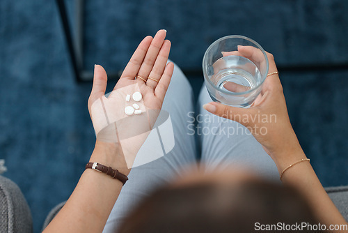 Image of Hands, pills and water in glass with health, sick person and pharmaceutical iron supplement for medical problem. Healthcare, top and pharmacy drugs in palm, pain relief and prescription medicine