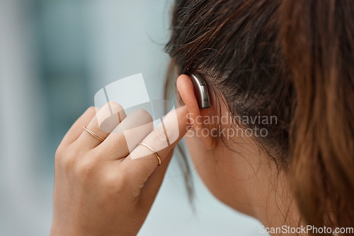 Image of Hearing aid, closeup and ear of woman with disability from the back for medical support, listening or healthcare tech. Deaf female patient with audiology implant for sound waves, amplifier and volume