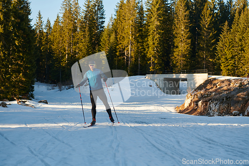 Image of Nordic skiing or Cross-country skiing classic technique practiced by man in a beautiful panoramic trail at morning.Selective focus.