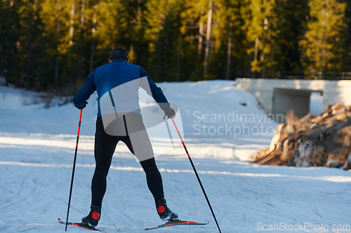 Image of Nordic skiing or Cross-country skiing classic technique practiced by man in a beautiful panoramic trail at morning.Selective focus.