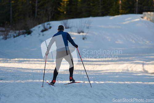 Image of Nordic skiing or Cross-country skiing classic technique practiced by man in a beautiful panoramic trail at morning.Selective focus.