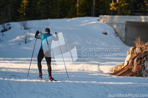 Image of Nordic skiing or Cross-country skiing classic technique practiced by man in a beautiful panoramic trail at morning.Selective focus.