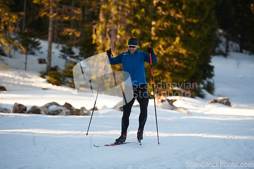 Image of Nordic skiing or Cross-country skiing classic technique practiced by man in a beautiful panoramic trail at morning.Selective focus.