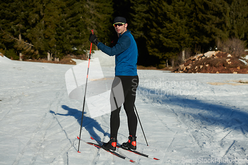 Image of Nordic skiing or Cross-country skiing classic technique practiced by man in a beautiful panoramic trail at morning.Selective focus.