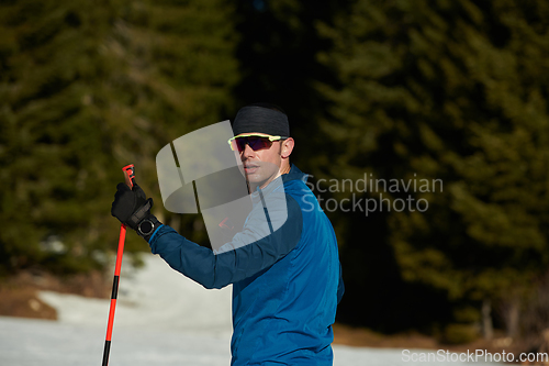 Image of Nordic skiing or Cross-country skiing classic technique practiced by man in a beautiful panoramic trail at morning.Selective focus.