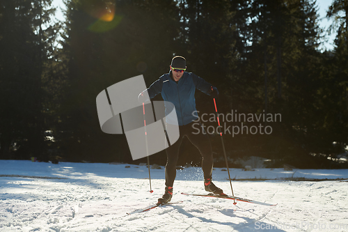 Image of Nordic skiing or Cross-country skiing classic technique practiced by man in a beautiful panoramic trail at morning.Selective focus.