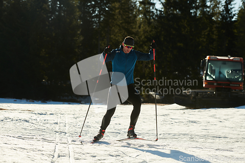 Image of Nordic skiing or Cross-country skiing classic technique practiced by man in a beautiful panoramic trail at morning.Selective focus.