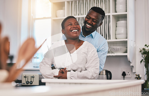 Image of Hug, kitchen and happy black couple laugh, bond or enjoy quality time together, funny conversation or chat in Nigeria home. Love, marriage and African people humour, embrace and smile at comedy joke