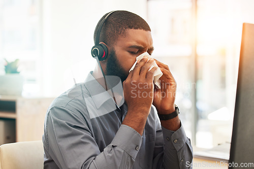 Image of Call center, sick and black man with a virus, allergy or customer service agent with health issue, illness or bacteria. Male person, employee or consultant with flu, fatigue or allergies in an office