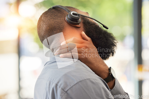 Image of Black man, neck pain and working in call center, injury and sick customer service employee with health problem. Male consultant, CRM and headset with mic, fibromyalgia and muscle tension with stress