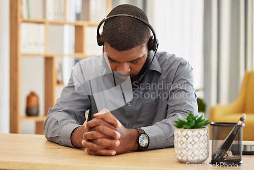 Image of Call center, stress and black man praying in office for workload, relief or mistake at desk. Telemarketing, fail and guy consultant pray for help with depression, anxiety or customer service pressure