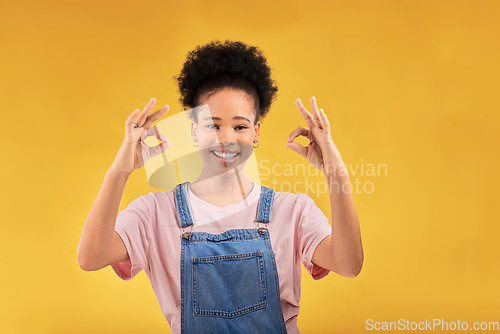 Image of Portrait, perfect and hand gesture with an excited black woman in studio on a yellow background. Smile, wow and okay with a happy young female person showing a sign of support, feedback or review