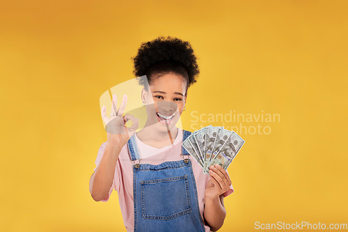 Image of Okay, money and winner with portrait of black woman in studio for success, prize or achievement. Bonus, lottery and investment with person and cash on yellow background for dollar, profit or giveaway