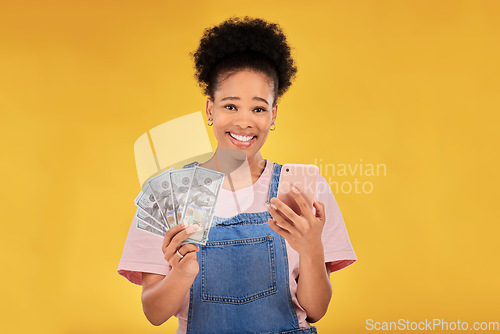 Image of Phone, money and winner with portrait of black woman in studio for success, prize or online payment. Bonus, lottery and fintech with person and cash on yellow background for dollar, sale or giveaway