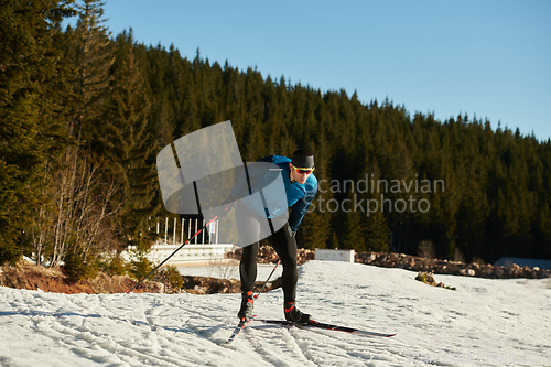 Image of Nordic skiing or Cross-country skiing classic technique practiced by man in a beautiful panoramic trail at morning.Selective focus.