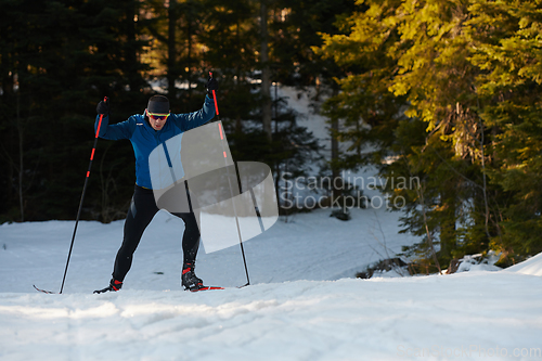 Image of Nordic skiing or Cross-country skiing classic technique practiced by man in a beautiful panoramic trail at morning.Selective focus.