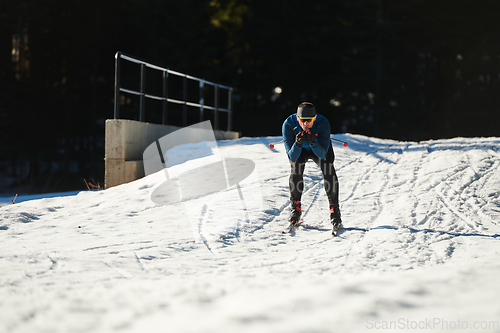 Image of Nordic skiing or Cross-country skiing classic technique practiced by man in a beautiful panoramic trail at morning.Selective focus.