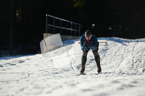 Image of Nordic skiing or Cross-country skiing classic technique practiced by man in a beautiful panoramic trail at morning.Selective focus.