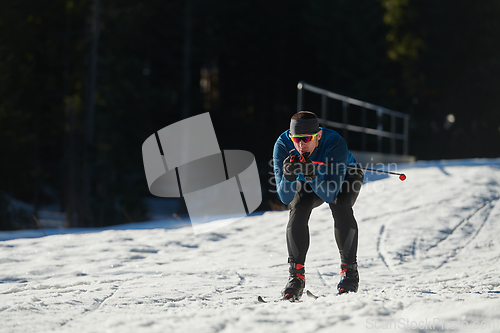 Image of Nordic skiing or Cross-country skiing classic technique practiced by man in a beautiful panoramic trail at morning.Selective focus.