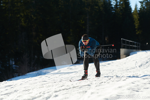 Image of Nordic skiing or Cross-country skiing classic technique practiced by man in a beautiful panoramic trail at morning.Selective focus.